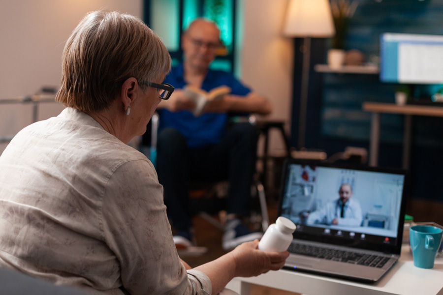 NEW---caucasian-old-woman-using-online-conference-video--X8P288K