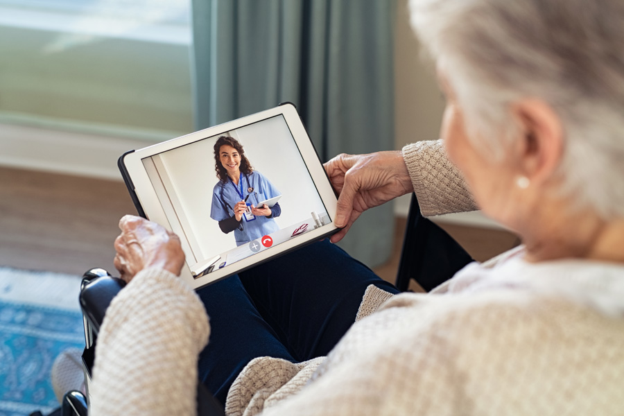 NEW---doctor-on-video-call-with-disabled-senior-patient-DV6AKXK