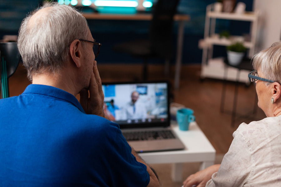 NEW---elderly-couple-using-video-call-for-dentist-advice-8WWY7PQ