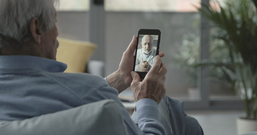 NEW---elderly-man-video-calling-his-doctor-KKL5WJ4
